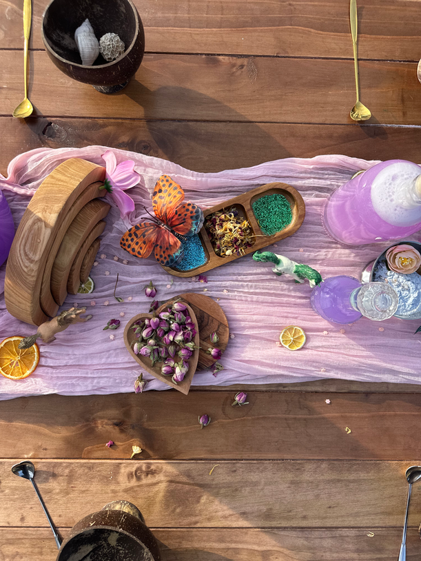 Colorful sensory play table with flowers and natural materials at event