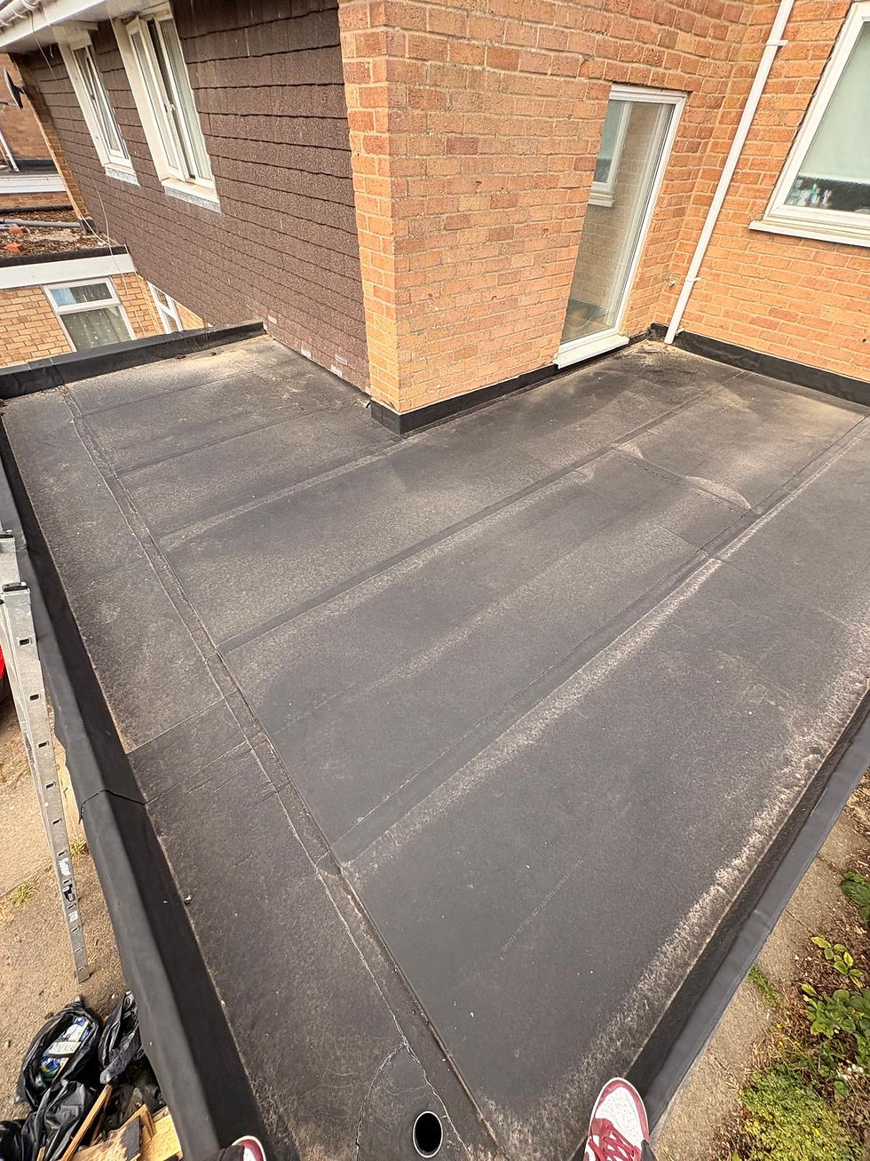 Resitrix flat roof with parapet walls, internal gully and wall flashings, installed to improve drainage and prevent standing water