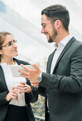 happy-businessman-businesswoman-standing-outside-office-looking-each-other.jpg
