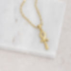 Small ankh necklace flay lay in gold