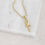 Thumbnail: Small ankh necklace flay lay in gold