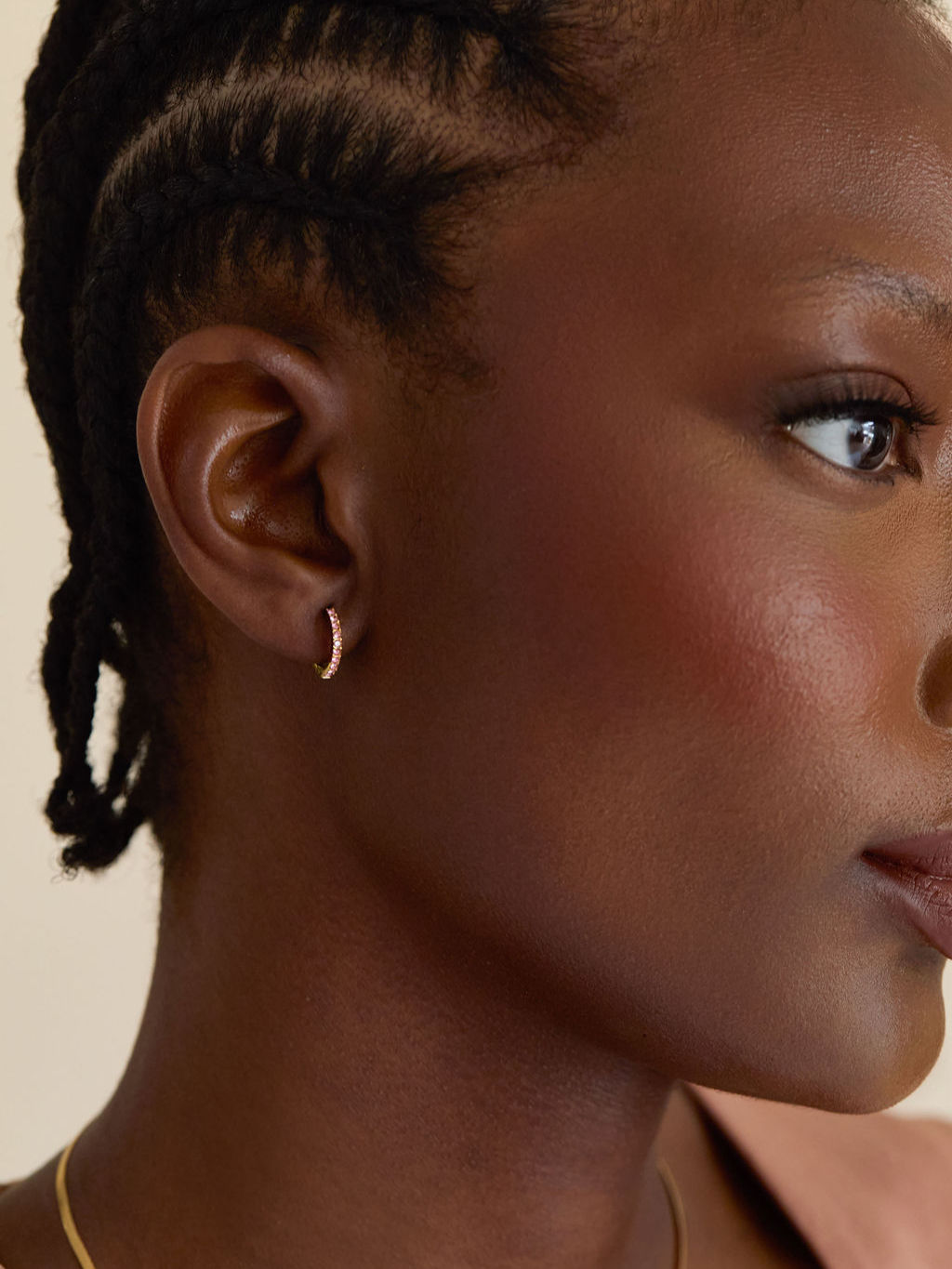 Birthstone colour huggie earrings worn on model - october