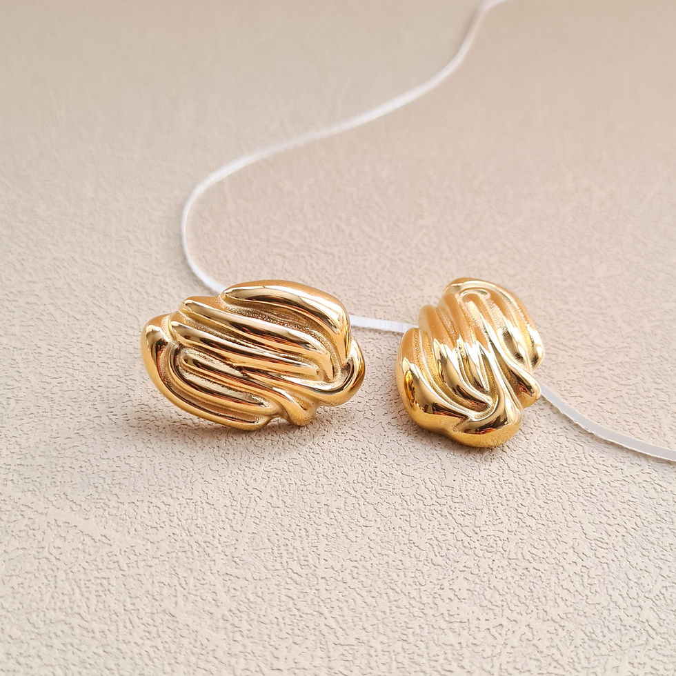 Thumbnail: gold whipped swirl stud earrings on beige textured background