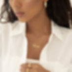 Model wearing custom name necklace with waterwave style chain
