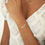 Thumbnail: Model wearing a custom personalised name bracelet in gold saying Marsha