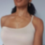Black girl wearing gold ankh earrings