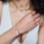 Model wearing gold chain and bracelet gift set