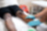 Physical therapist examines a patient's leg and discusses benefits of compression therapy