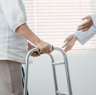 Patient with hands on walker grips
