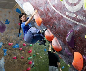 Person climbing on indoor bouldering wall at The Mothership