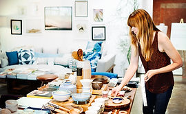 Shop Owner Arranging Merchandise