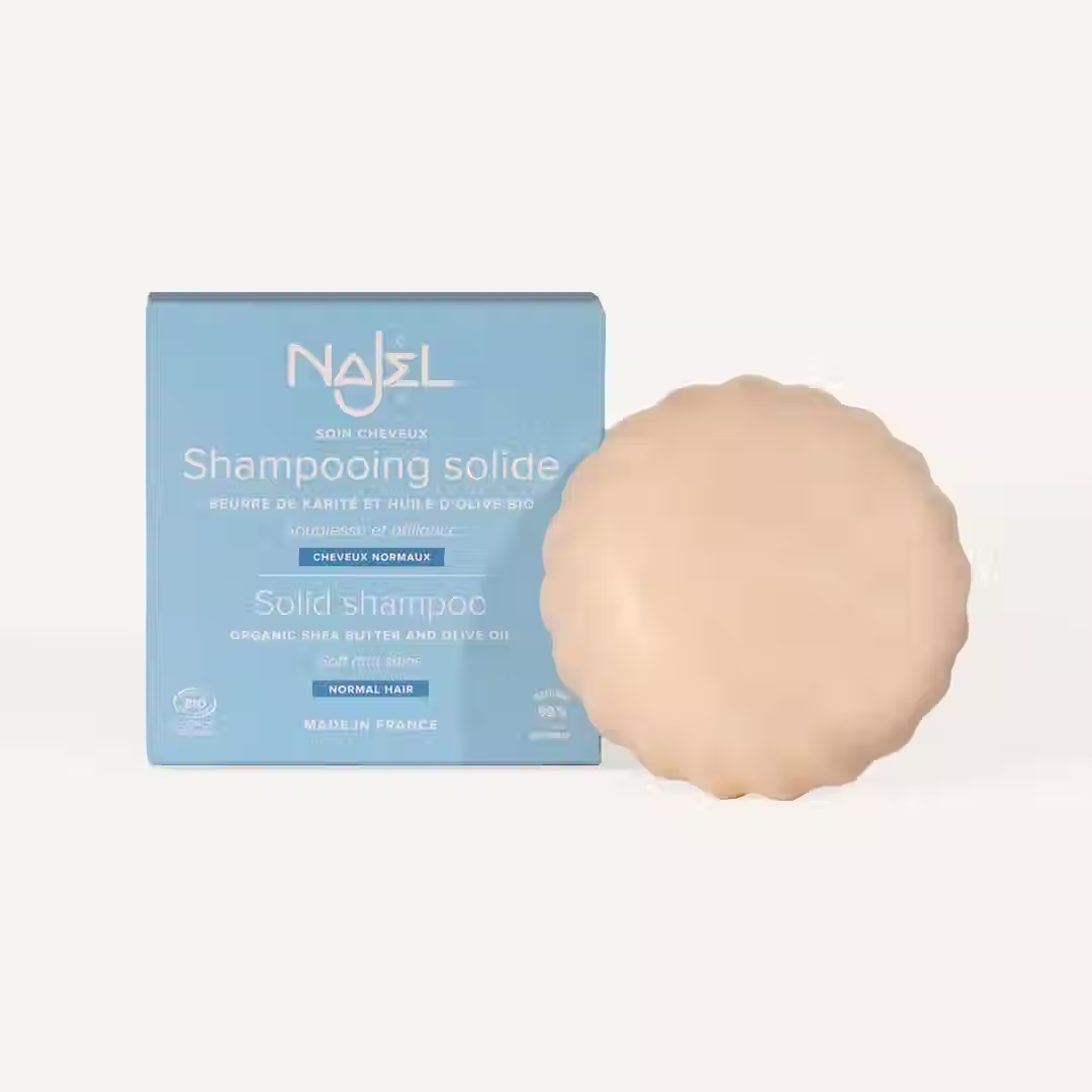 Najel solid shampoo with shea butter and olive oil beside blue packaging