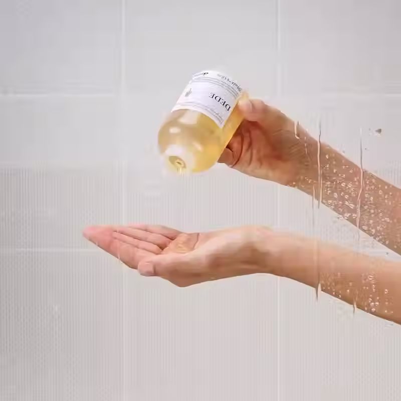 Thumbnail: Davines DEDE Shampoo 250ml being poured into hands during application