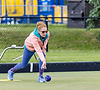 Woman rolling a purple lawn bowl
