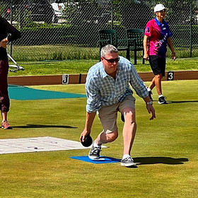 Lawn bowler delivering a bowl