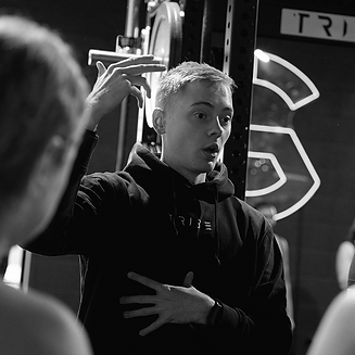 Personal trainer giving guidance to clients.png