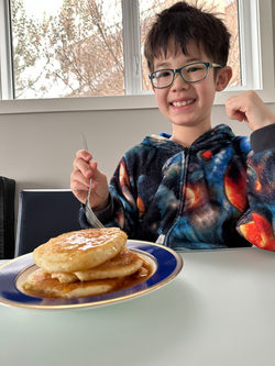 Eating the pancakes he made himself