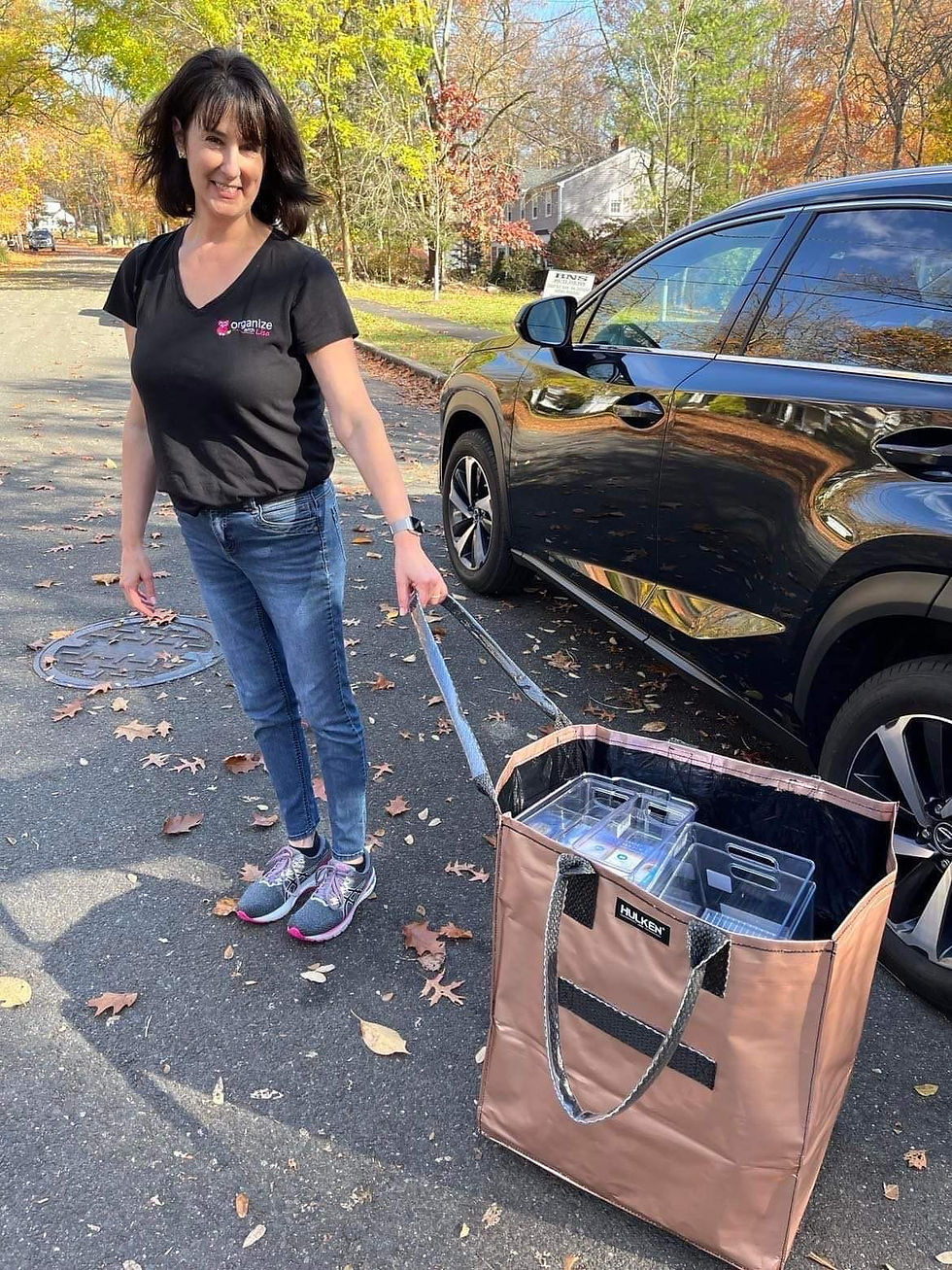 Organize With Lisa's founder and professional organising expert, Lisa Harris, outside carrying a Hulken Bag to her client's house.