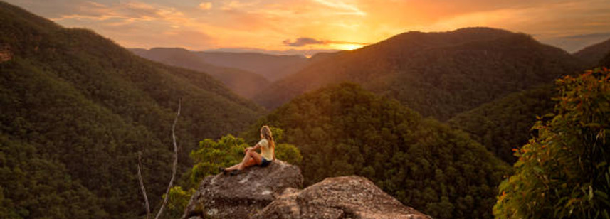 woman on top of mountain with breathtaking view