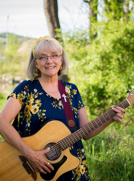 Gena McMyne Holding A Guitar