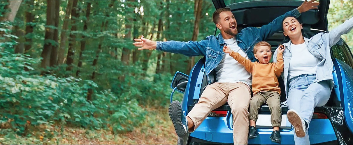Happy family enjoying a road trip after saving with affordable car insurance and full coverage car