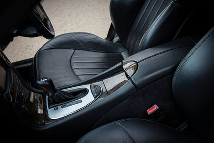 a car with black leather seats and a silver shifter