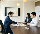 Three_Japanese_business_professionals_gathered_aro-1776620509361.png