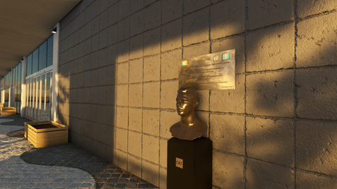 Close-up of the landmark bust and plaque located at the entrance of the Madeira Airport terminal.