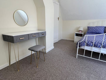 A modern dressing table and stool in a double bedroom on Round Island, Poole