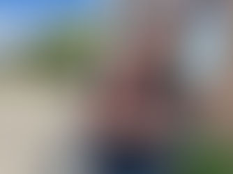 Two daycamp volunteers piggyback outdoors.