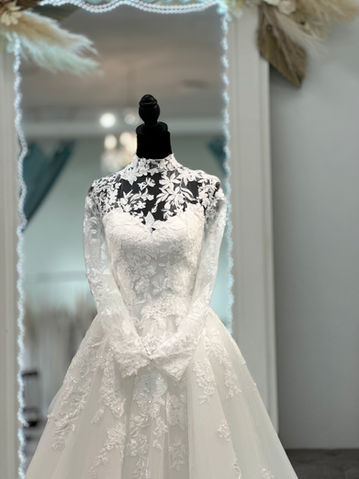 Bride Smiling In Dress Fitting At Adore Bridal Boutique