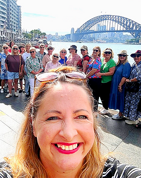 Jacqui Jones and a group of women on a Flourish Experiences tour of Sydney in front of the Sydney harbour bridge