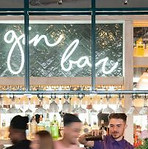 gin bar light up sign with drink at bar 