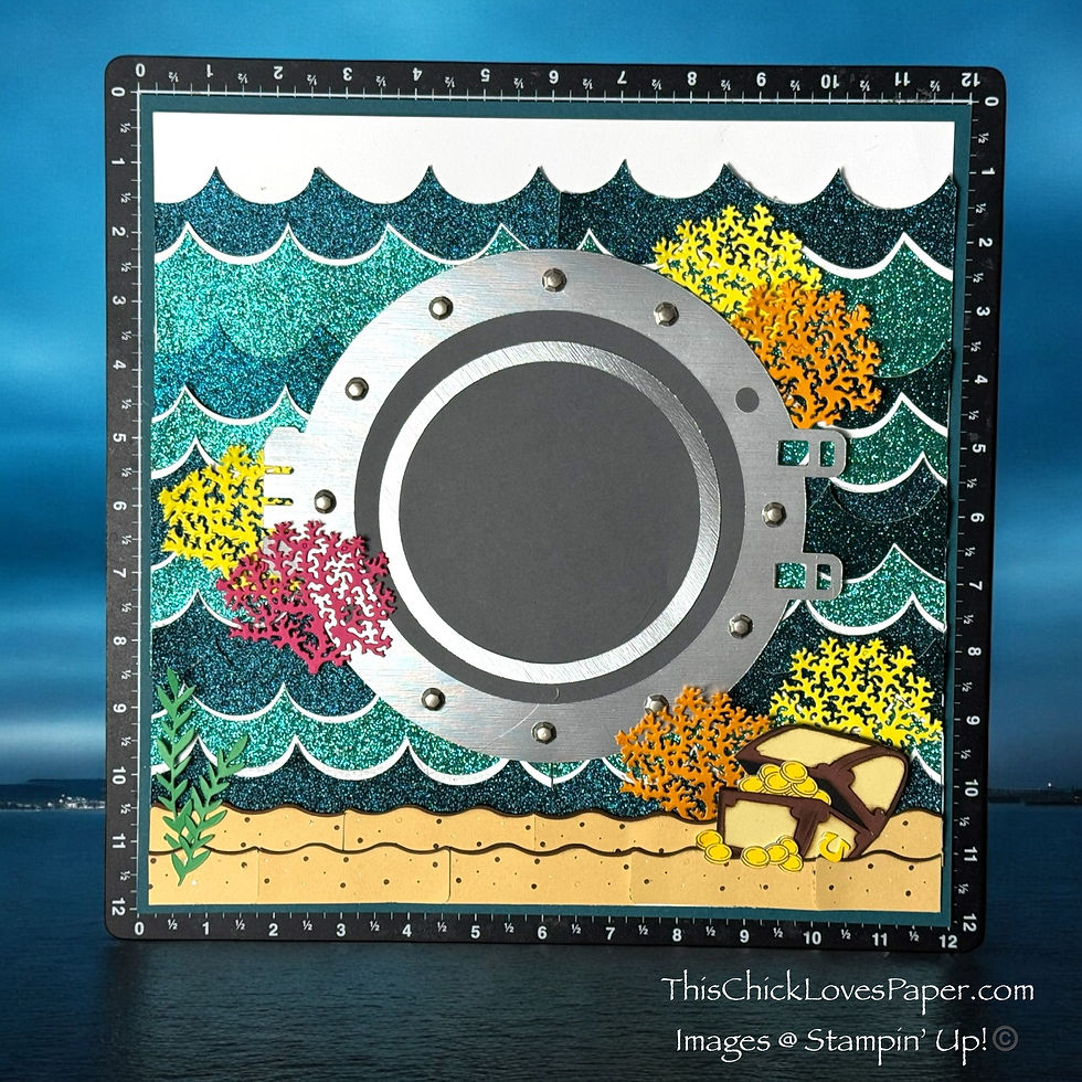 Underwater-themed craft with a porthole, colorful coral, and treasure chest on glittery blue waves. Text: ThisChickLovesPaper.