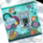 Scrapbook page featuring The Little Mermaid theme, with Ariel stickers, glittery patterns, and a central photo of The Little Mermaid entrance.