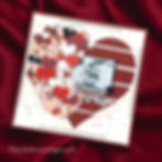 Scrapbook page on red fabric, with a vintage photo labeled "Grandma & Me," surrounded by layered hearts in red, pink, and patterns.