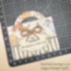 Paper craft with animals, a bow, and text: "Oh, bother. You deserve a little treat." Set on a grid-pattern cutting mat.