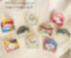 Colorful handmade gift bags displayed on a beige surface, with designs like "Thank You Teacher" and "Dog Treats," featuring stars and hearts.