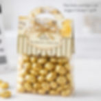 Bag of gold-wrapped chocolates with a label reading "Oh, bother. You deserve a little treat" and Winnie-the-Pooh design, against a soft background.