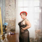 Woman in negligee looking at herself in a mirror