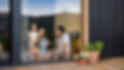 Young family with small daughter indoors, weekend away in container house in countryside..