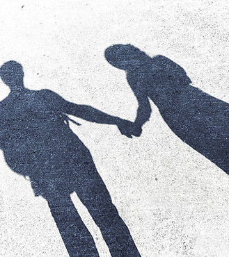 Couple standing together holding hands