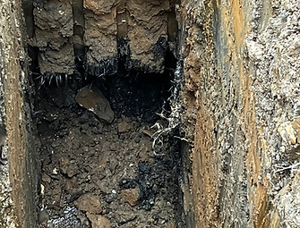 Trial pit containing Made Ground and waste
