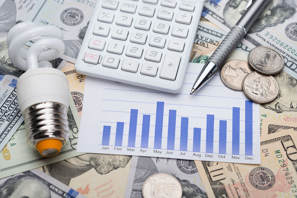 A light bulb pictured with calculator, cash and coins demonstrates rising electricity costs
