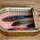 Thumbnail: Sardine can sculpture with wax-modeled fish and wooden swordfish engraving by Ortaire de Coupigny, titled Tropical Waters.