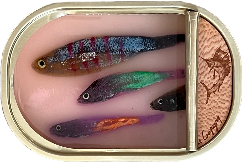 Four colorful sculpted fish float in a sardine can sculpture by Ortaire de Coupigny with a wooden swordfish engraving.