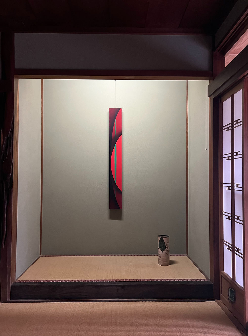 Traditional Japanese tokonoma alcove with contemporary vertical artwork and ceramic vessel at Art San Gallery
