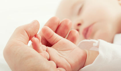 new mom holding new baby hand