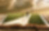 Image of a Bible with a man walking on a path to a cross in the background, clouds in the sky.