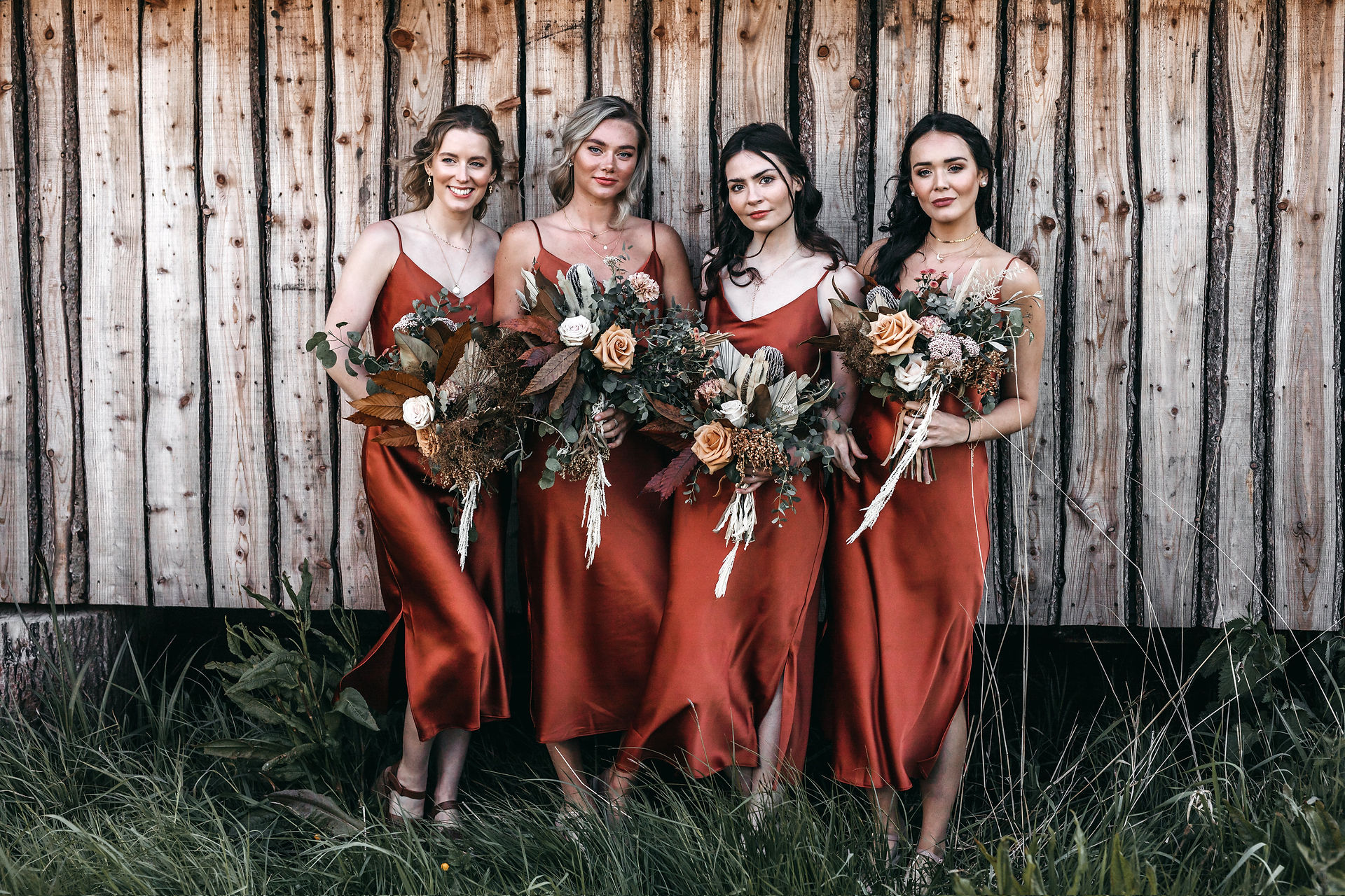 rust coloured bridemaid dresses and dried flowers